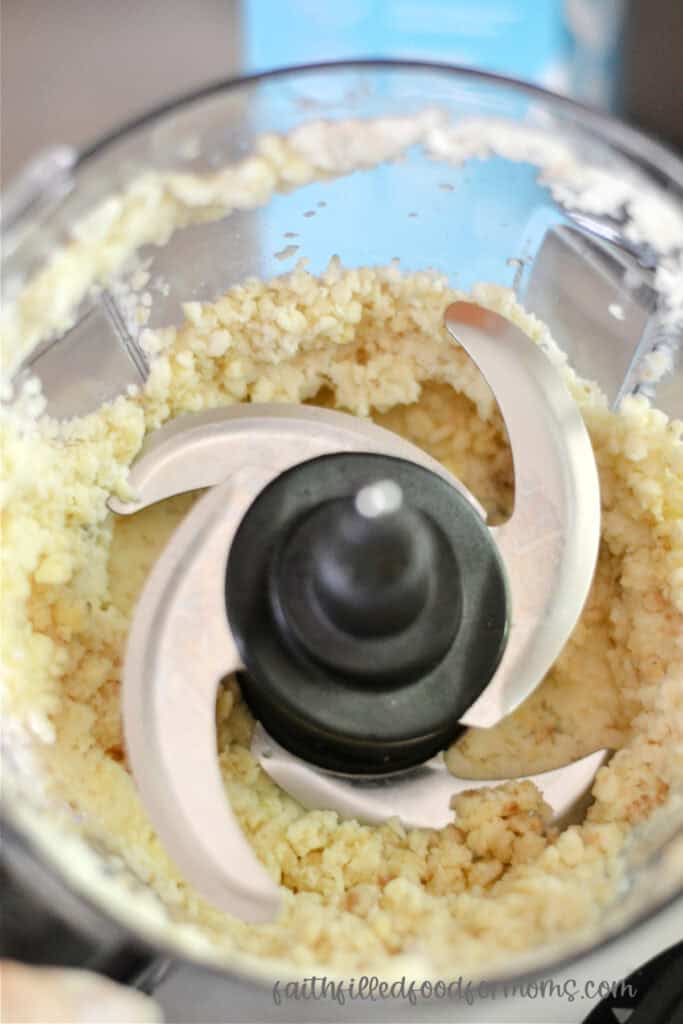 Partially blended frozen bananas in blender. They are kind of course and chunky