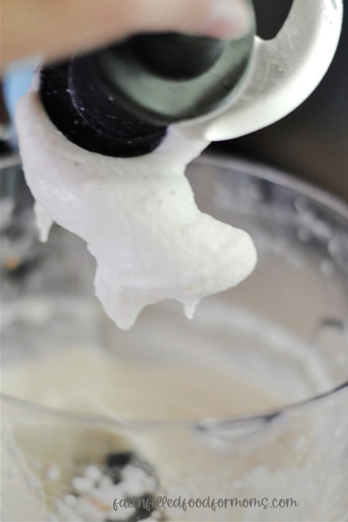 Pulling blade out of Ninja food processor. It has nice creamy banana ice cream on it.