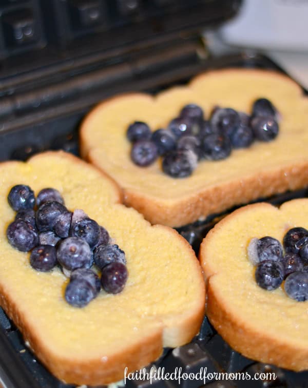 Blueberry Stuffed French Toast Waffles on waffle iron