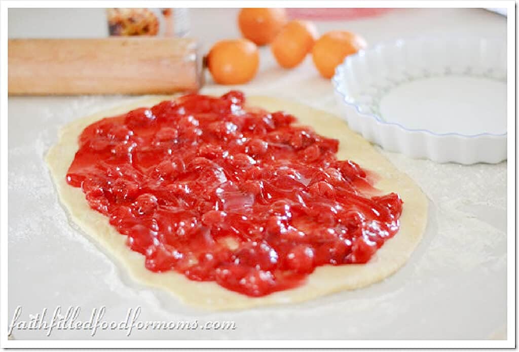 sweet rolls canned cherry filling on rolled out dough