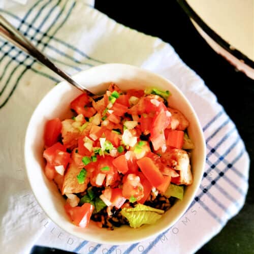 Top down look at a chicken burrito bowl with pico de gallo on top!