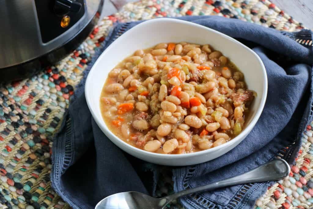 Crockpot ham and beans Bowl of ham and bean soup with spoon