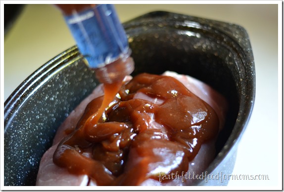 pulled pork sandwich with barbeque sauce pouring a bottle of BBQ sauce over pork in a roasting pan