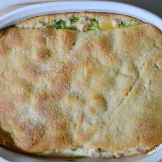 Easy Cheesy Layered Chicken Breast with broccoli, chicken and a golden brown crescent topping.