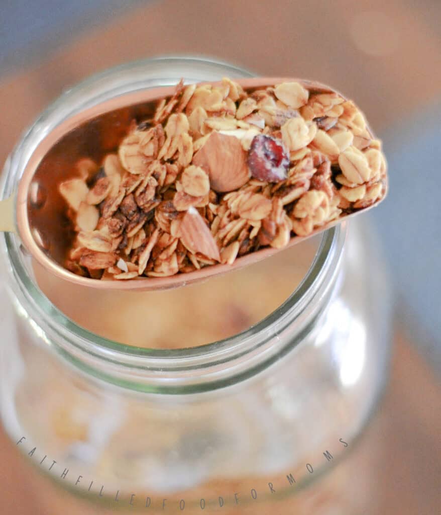 Easy Homemade Simple Granola Recipe scoop of granola sitting on top of mason jar.