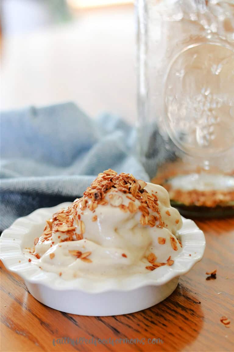 Banana Ice Cream in a white bowl with homemade Granola sprinkled on top