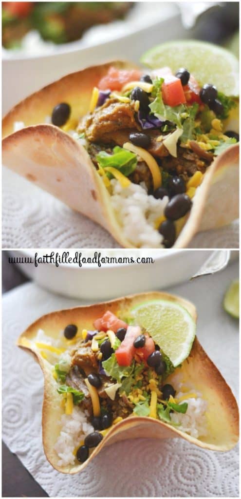 Homemade Tortilla Bowls filled with white rice, pork carnitas, black beans, tomato, lettuce and cheese. With a slice of Lime next it.