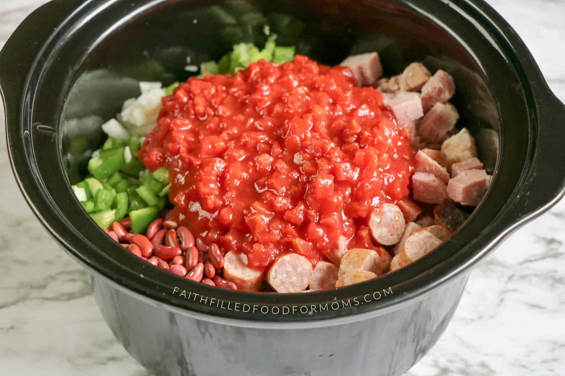 kielbasa and beans slow cooker Another shot of the crockpot with all ingredients except it has the canned tomato's on top