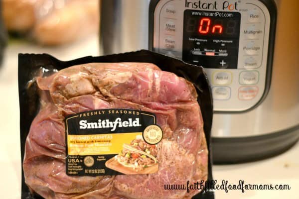 Pork Carnitas in a package in front of  an instant pot.
