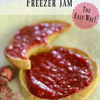 No cook Raspberry Freezer Jam on English Muffin with a bite out of it.