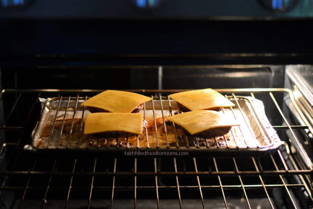 Frozen hamburgers with melted cheese Oven-baked frozen hamburgers topped with melted cheese while broiling.