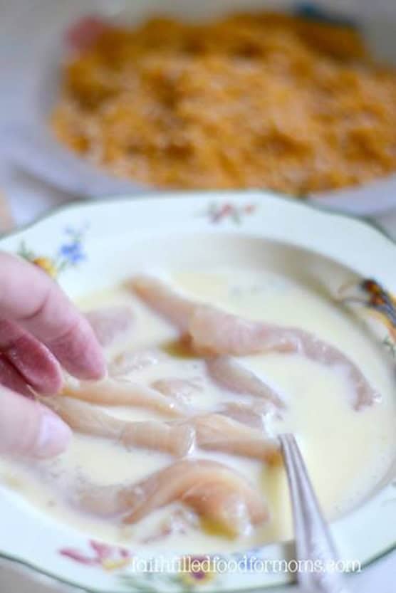 Crispy Homemade Baked BBQ Chicken Breast Tenders Chicken Breast Strips in Milk and egg mixture.