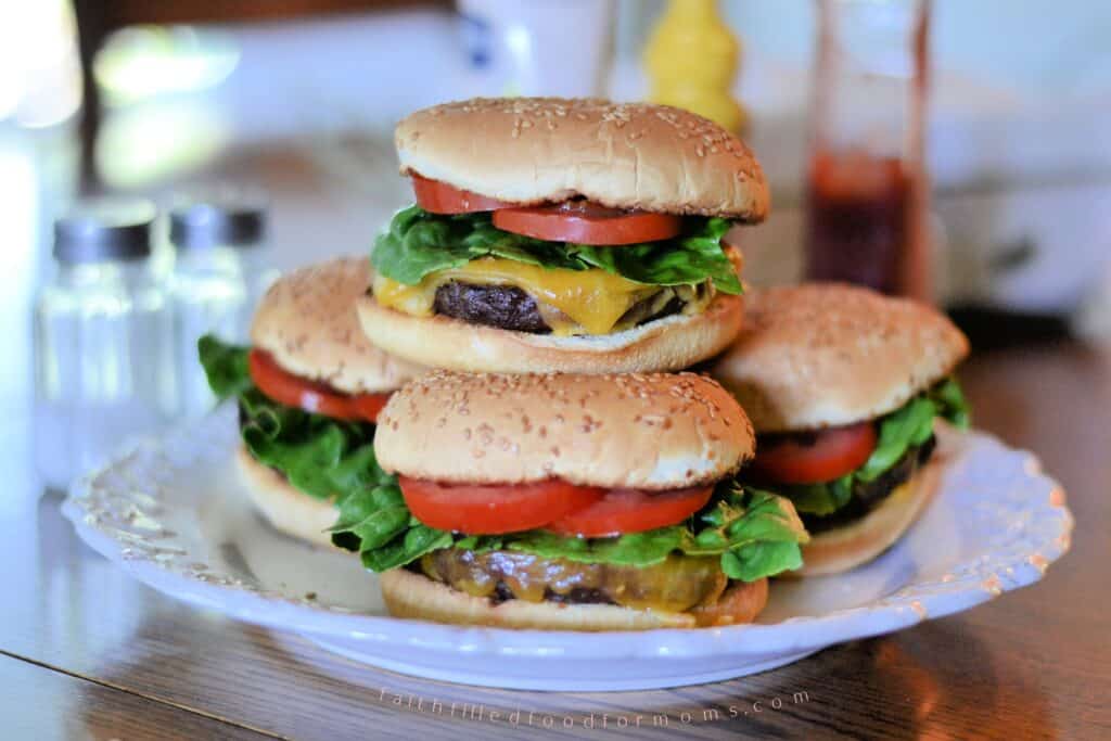Cheeseburgers made with frozen hamburger patties cooked in the oven for an easy family dinner.