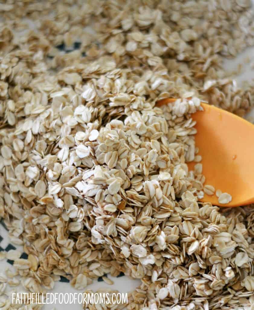 easy homemade granola recipe Whole oats being stirred with other ingredients.