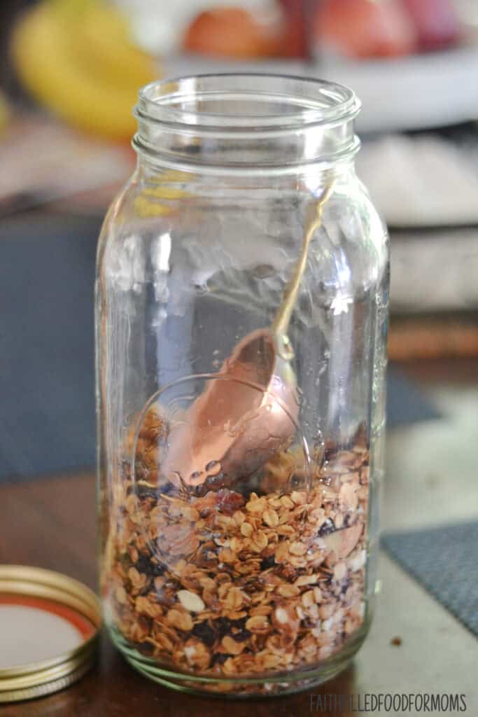 Easy Homemade Simple Granola Recipe granola in a mason jar with scoop